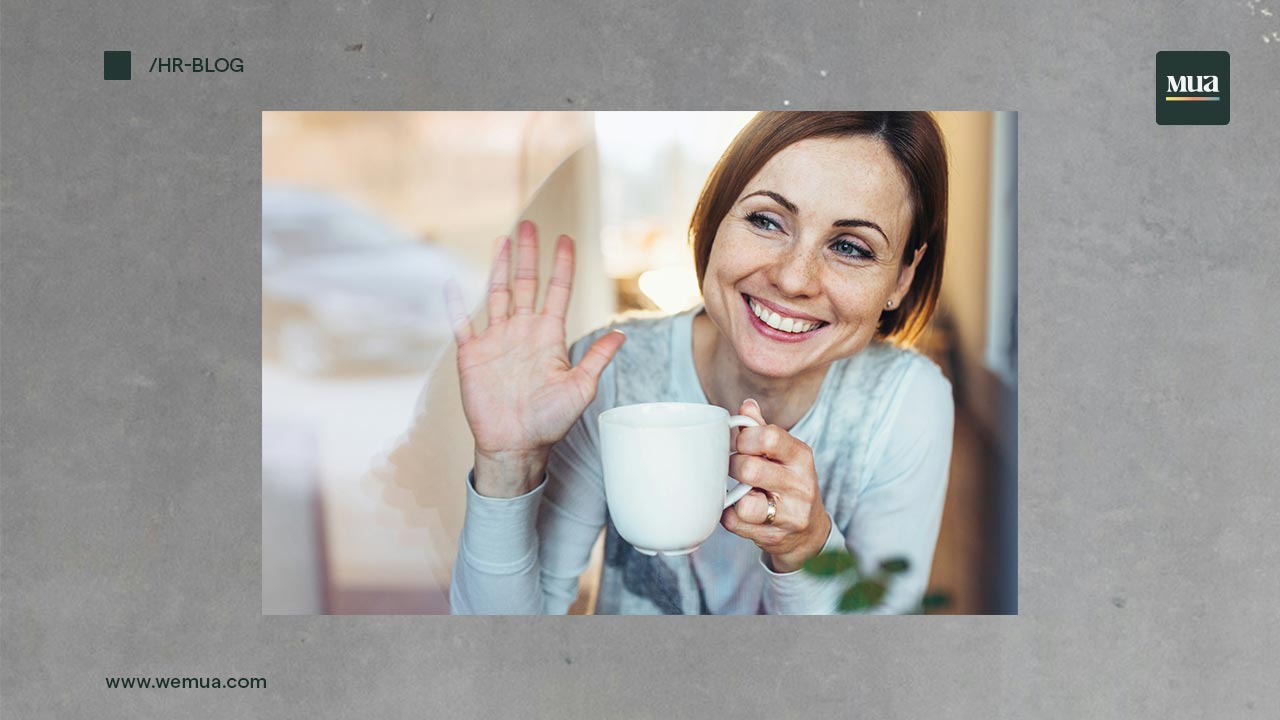 person in cafe waving